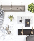 Ruavista Single Coat And Hat Hook In Venetian Bronze With Copper Highlights on white background with decor items