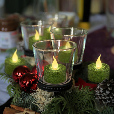 Green Glitter Flameless Tealight Candles 1.5 Inch By 1.65 Inch in glass holders as a centerpiece with red ornaments and greenery