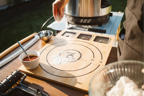 Large Bamboo Cutting Board With 3 Shatter Resistant Containers And Lids For Kitchen Prep in use during outdoor cooking