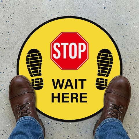Five Pack Stop Here Floor Signs 18 Inch Round Vinyl Anti Slip High Visibility Stickers For Quick Queue Control And Social Distancing In Busy Places No Fuss, yellow STOP WAIT HERE floor decal on store floor