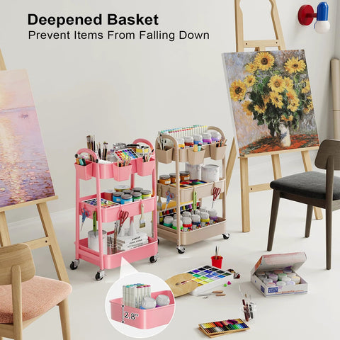 Beige 3 Tier Rolling Cart With Metal On Wheels in art studio, holding paints and supplies, alongside a pink version loaded with brushes.