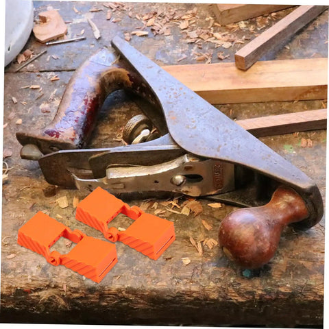 Four Piece Woodworking Strap Clamp Blocks For Quick Fix Belt Clamp Accessories on wooden workbench with hand plane