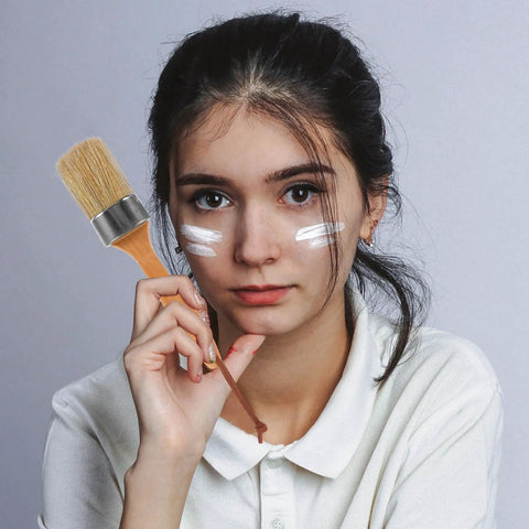 Person holding a Two Piece Wood Handle Paint Brush Set With Oval Synthetic Bristles For Deck Stain On Wood, Fence And Furniture