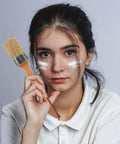 Woman holding Two-Piece Wood Handle Paint Brush Set For Walls And Decks, Oval Synthetic Bristle Brushes For Furniture Renovation