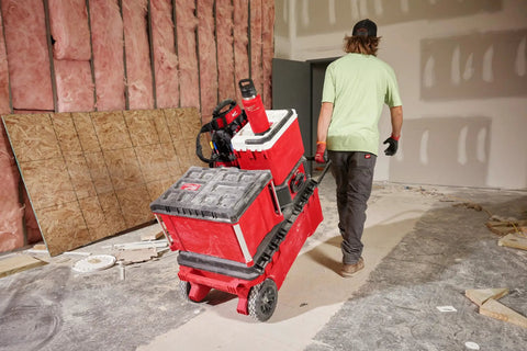 Worker pulling cart with Packout 36oz Insulated Bottle With Chug Lid All Day Thermal Retention Double Wall Vacuum Insulation.