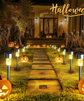 Sun Powered Solar Pathway Lights Outdoor Waterproof Stainless Steel LED Garden Lights lining a Halloween-themed path