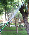 Lightweight 18 Inch Watering Wand With 9 Pattern Spray, Pivoting Head And Thumb Control in use watering a tree.