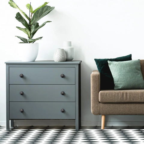 Bedroom scene with gray dresser featuring 60 Pack Matte Black Kitchen Cabinet Knobs One And A Quarter Inch Round Drawer Pulls.