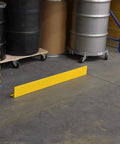 Rugged Yellow Steel Floor Safety Curb Warehouse Workhorse 48 Inch Heavy Duty Protective Barrier along warehouse floor.