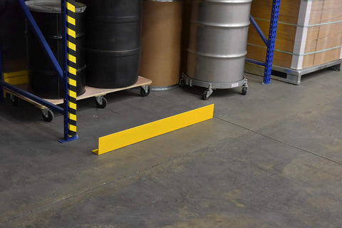 Rugged Yellow Steel Floor Safety Curb Warehouse Workhorse 48 Inch Heavy Duty Protective Barrier along warehouse floor.