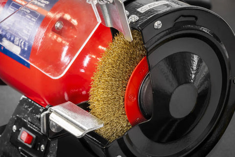Close-up of Workhorse 150Mm Bench Grinder Equipped With A Beefy 450W Induction Motor showing heavy steel wire brush for cleaning.