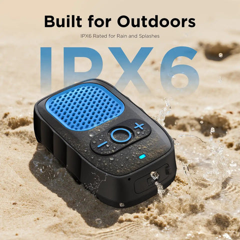 Wearable Bluetooth Speaker With All Day Battery Life And Clip On Convenience For Job Sites Water Resistant Pro Portable Speaker With Built In Mic For Hands Free Music And Calls Blue Non Magnet placed on wet sand showcasing water resistance