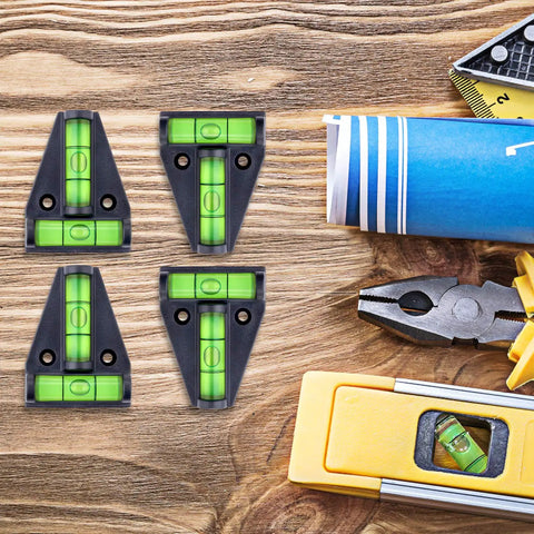 Four Piece T Type RV Level Kit with Bubble Leveler for precise leveling of campers and trailers, shown with tools on wood surface