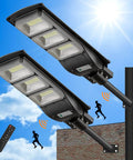 Dual Mega Bright 4000W LED Solar Street Lights Outdoor With 400000LM on pole, with remote and motion sensor icons against sky