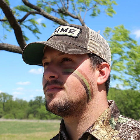 Hunter wearing 3 Color Camo Face Paint Stick For Hunting With Mess Free Application Long Lasting Concealment Makeup in nature