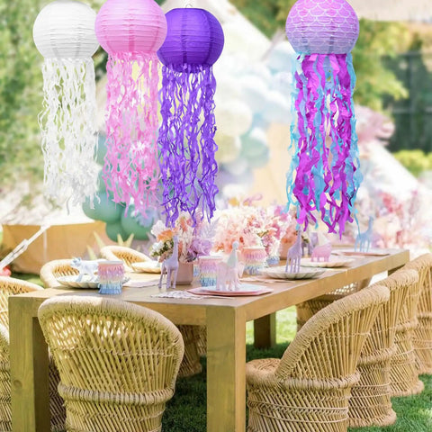 Jellyfish Paper Lanterns 6 Pack Hanging Lit Colorful Lanterns For Mermaid Unicorn Theme Classroom Decor Under The Sea Ocean Birthday Party Decorations For Undersea Parties Classroom Decor And Birthday Celebrations with pink, white, and purple lanterns over a table.