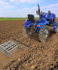 Blue tractor towing 4 Foot By 5 Foot Chain Harrow For ATV And UTV Tractor Attachments in field, showing wide coverage and easy assembly