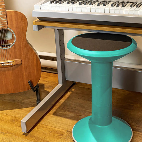 Teal wiggle stool for class and home study by a keyboard and guitar, flexible seating adjustable 12 to 18 inch height
