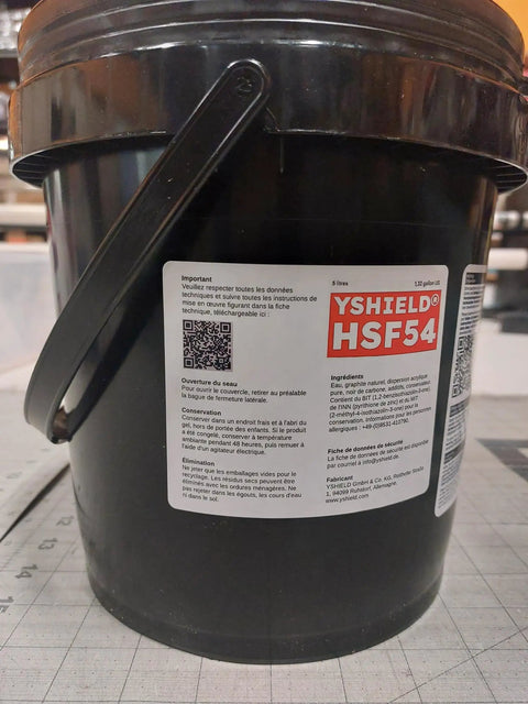 Close-up of a black bucket labeled EMF Shielding Paint Kit 5L For Home And Office That Blocks Cell Towers WiFi And 5G Signals With Attenuation