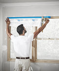Person using Pro Grade Masking Film Kit With Static Cling 8 Rolls Of 48 In By 180 Ft Each Keeps Film In Place Flake Resistant Indoors