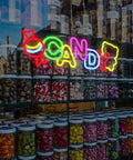 Colorful neon candy sign above jars of sweets in a shop window display