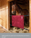 Stall guard for horse barn with adjustable straps and sturdy spring hooks in water resistant 1680D polyester red in use