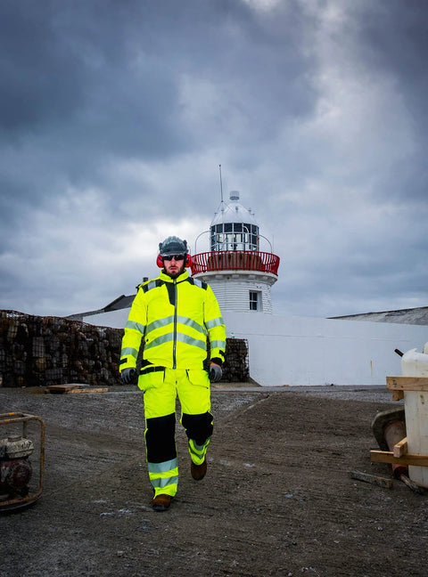Worker wearing Hi Vis Winter Work Jacket With Reflective Waterproof Shell And Thermal Quilted Lining ANSI 3 Safety Coat X Large