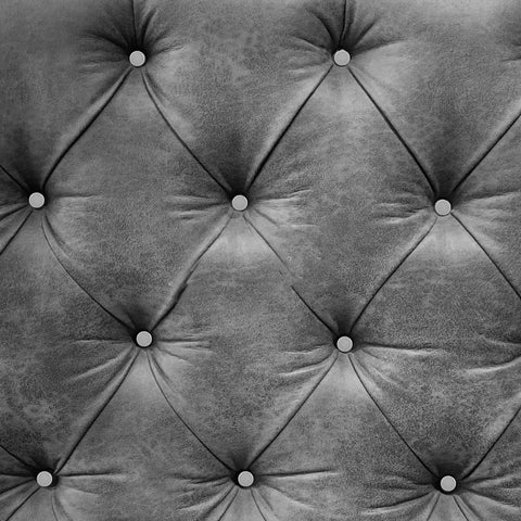 Kick Up Your DIY Game With Sleek Stainless Steel Upholstery Tacks Delivered Straight To Your Door With Top Shelf Decorative Furniture Nails Designed For Easy Sofa And Headboard Projects on a gray tufted fabric headboard.