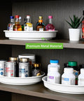 Smooth Spinning White Metal Lazy Susan Turntable Two Pack Compact Rotating Kitchen Cabinet Organizer And Countertop Rack For Pantry Storage with various bottles.