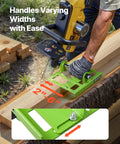 Person using Adjustable Chainsaw Mill 2 to 6 Inches Wide for vertical cuts, green mill attached to wooden log, closeup view.