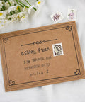 Three postage stamps on a brown envelope, surrounded by daisies, displaying decorative illustrations and handwritten address.