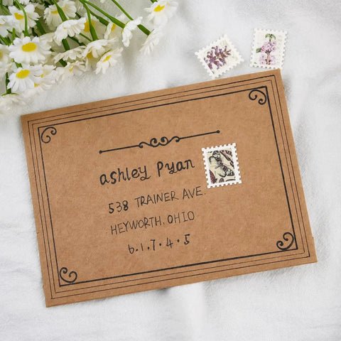 Three postage stamps on a brown envelope, surrounded by daisies, displaying decorative illustrations and handwritten address.
