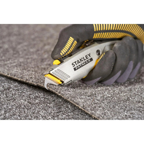 Hand holding 2 In 1 Snap Off Knife Xtreme with 9mm blade cutting grey material, stainless steel blade guide visible