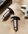 Two Pack Spring Loaded T Handle Pull Knobs With Badass Grip Built Tough As Nails For Welding Tables And Garage Shelves Locking Steel Shank Shock Proof Plastic Design Half Shank 3 15 Inches Long on wooden surface.