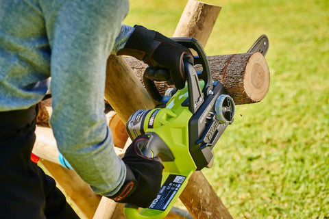 Hella Smooth 18V Brushless Battery Chainsaw With 30Cm Oregon Bar in use, cutting through logs with ergonomic grip and safety features.