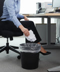 Woman tossing waste into No Mess Clear Trash Bags Bulk Bundle One Thousand Count Seven To Ten Gallon Scent Free Garbage Liners.