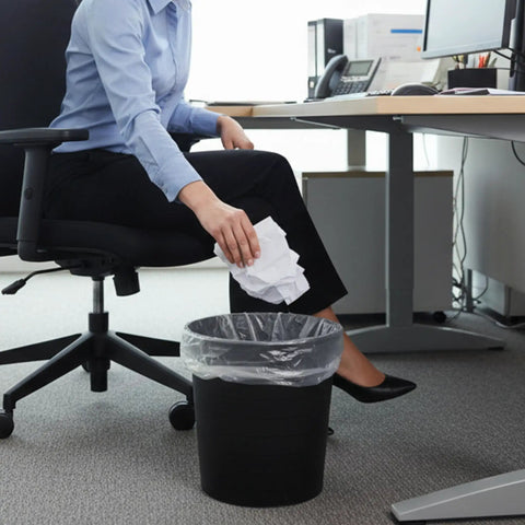Woman tossing waste into No Mess Clear Trash Bags Bulk Bundle One Thousand Count Seven To Ten Gallon Scent Free Garbage Liners.
