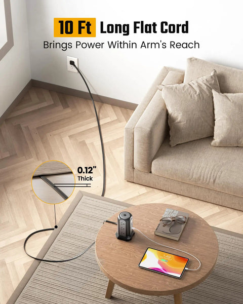 Nine Outlet Tower Surge Protector With Four USB Ports And A 10 Ft Cord shown on a desk in a home setting, grounded plug visible.