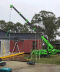Mini Portable Crawler Crane Rig With Smart Wireless Remote Hydraulic Lift Machine Fully Kitted Out lifting materials onto a roof.