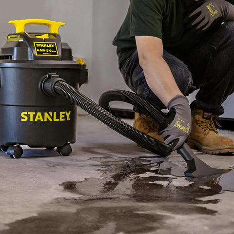 Powerful 5 Gallon Wet Dry Shop Vacuum With 4 Peak HP, 85 CFM in use cleaning wet floor, features swivel casters and 3 in 1 blower.
