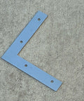 5 Inch Hot Dipped Galvanized Steel L Bracket Corner Brace Heavy Duty 90 Degree Mending Plate on concrete surface.