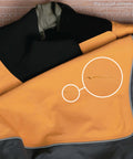 Orange and gray wader with close-up of tear, suitable for repair with Aquaseal FD Flexible Durable Repair Adhesive For Patch Up Tears In Waders Wetsuits PVC Inflatables Vinyl And Outdoor Gear Dries Clear In Any Weather 0.75 Oz 1 Pack.