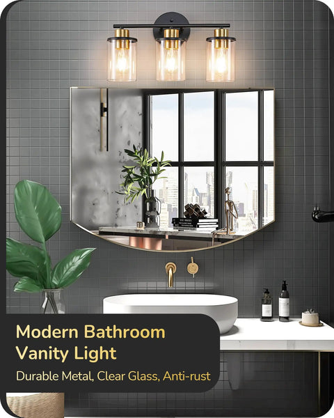 Chic Brushed Nickel 3 Light Vanity Light Over Mirror With Clear Glass Shades shown on dark tiled bathroom wall