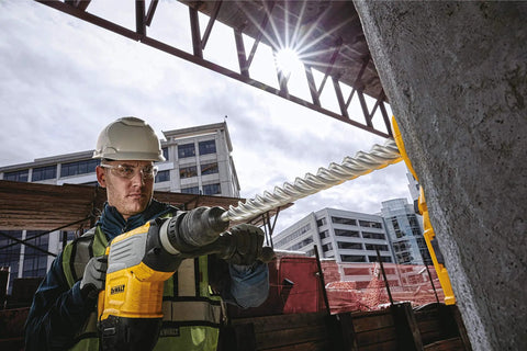 Worker using Iron Blast Technology SDS Max Drill Bit 1-3/4 Inch by 22-1/2 Inch with Full Carbide Head on construction site.