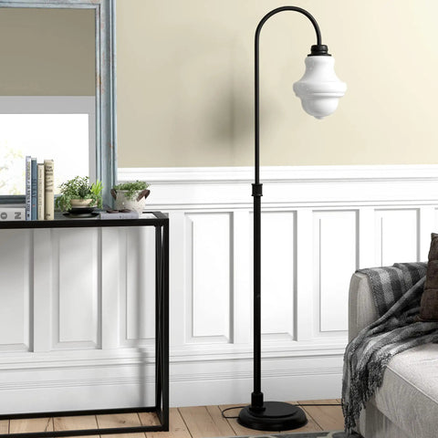 Tall Floor Lamp With Glass Shade In Blackened Bronze And White Milk Finish next to a console table in modern living room setting.