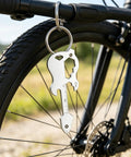 12 In 1 Guitar Themed Keychain Multi Tool With Bottle Opener Screwdrivers Hex Keys And Bike Spoke Wrench hanging on bike