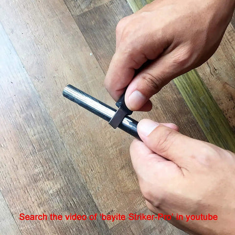 Hands using Survival Ferro Rod Fire Starter Kit With Drilled Ferrocerium Rod, 4 Inch Long By 0.375 Inch Diameter, Paracord Lanyard.