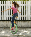 Child riding 20 Inch Outdoor Unicycle With Adjustable Seat For Adults And Kids, durable manganese steel frame, yellow green