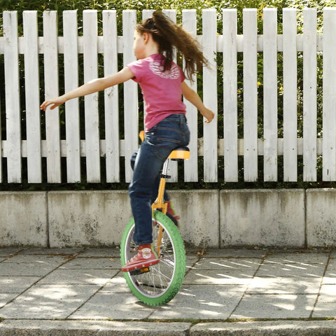 Child riding 20 Inch Outdoor Unicycle With Adjustable Seat For Adults And Kids, durable manganese steel frame, yellow green
