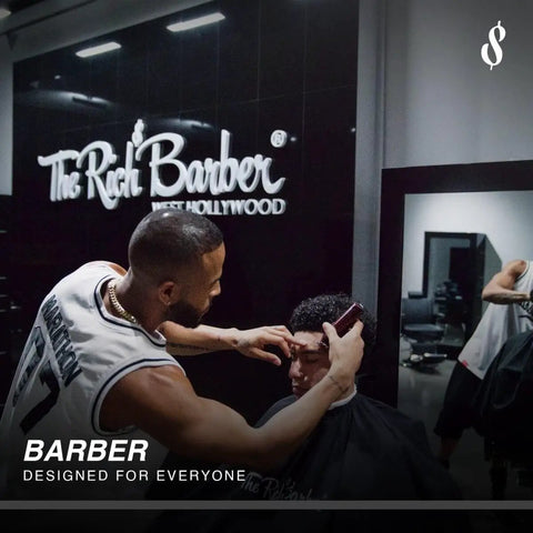 Barber using clippers on a client in The Rich Barber shop, featuring logos and modern interior design.